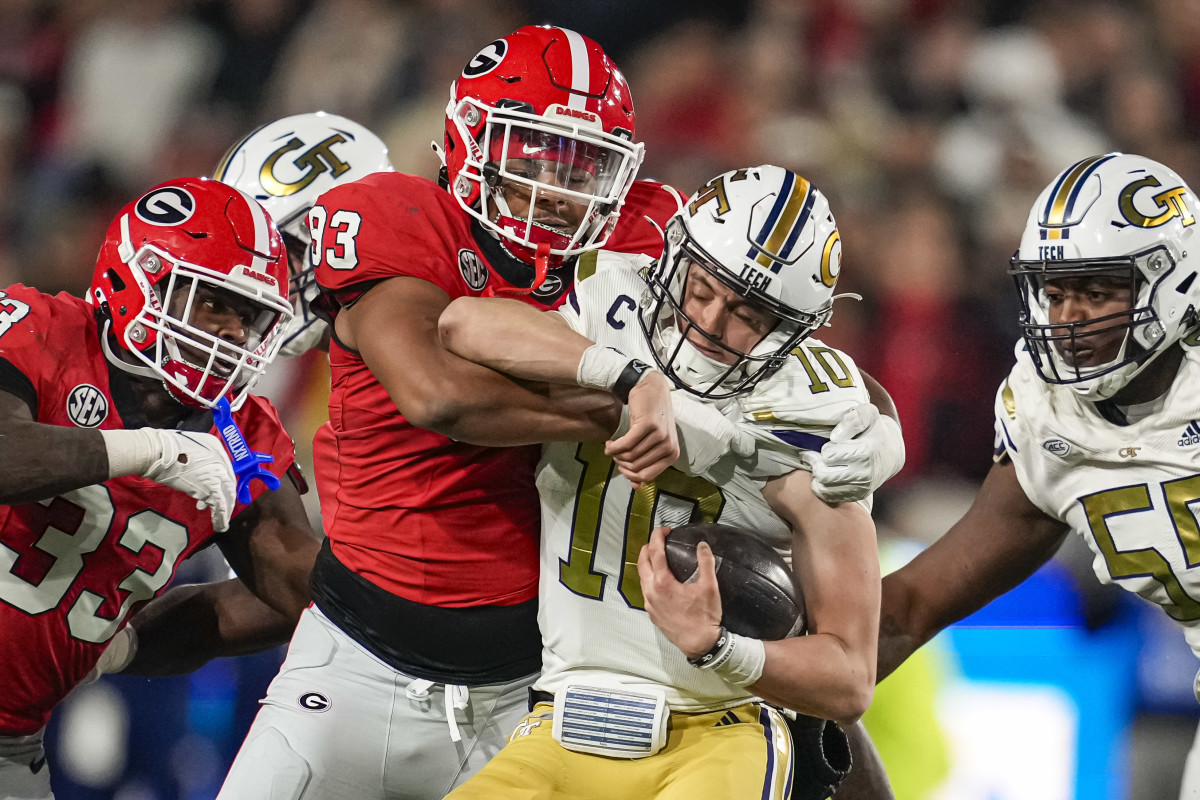 Nov 25, 2023; Atlanta, Georgia, USA; Georgia Bulldogs defensive lineman Tyrion Ingram-Dawkins (93) tackles Georgia Tech Yellow Jackets quarterback Haynes King (10) during the second half at Hyundai Field. Mandatory Credit: Dale Zanine-USA TODAY Sports  